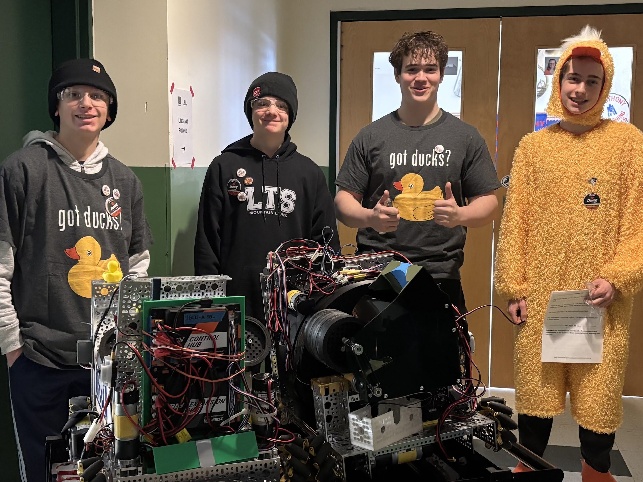 Ben, Liam, Zach, Miles (in full duck costume) with V1 and V2 robots.