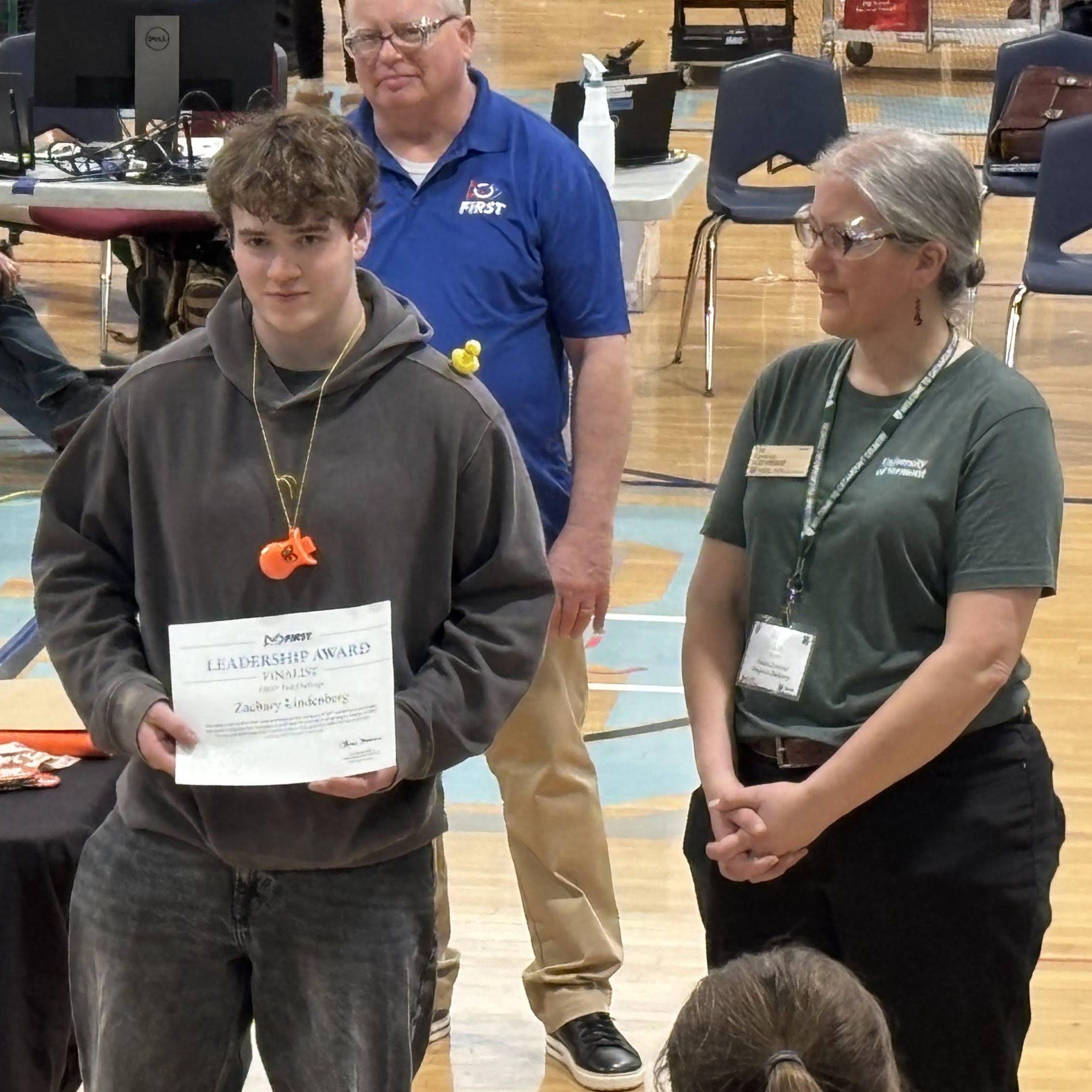 Zach accepts his Finalist Leadership Award from Liz Kenton