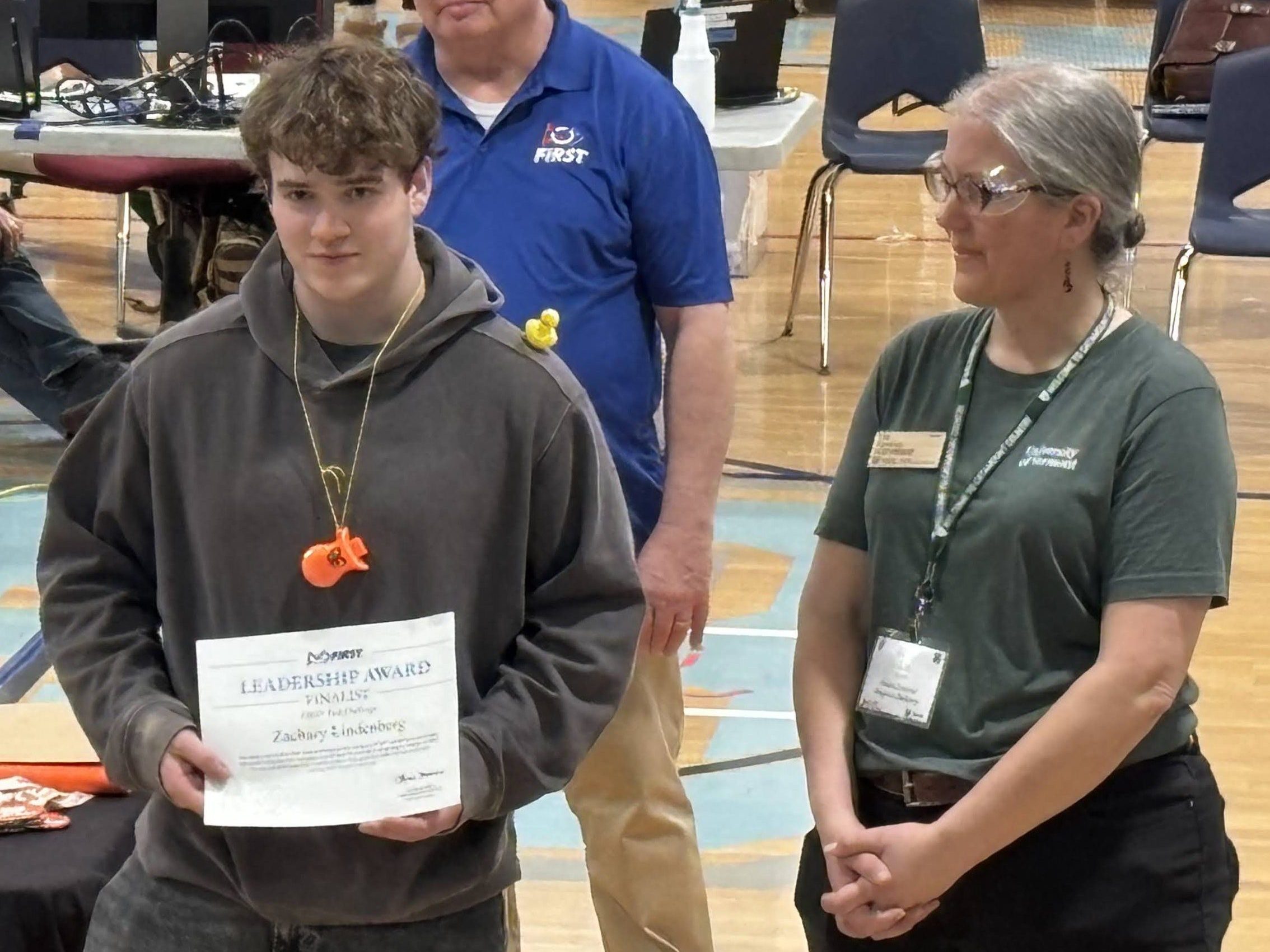Zach accepts his Finalist Leadership Award from Liz Kenton